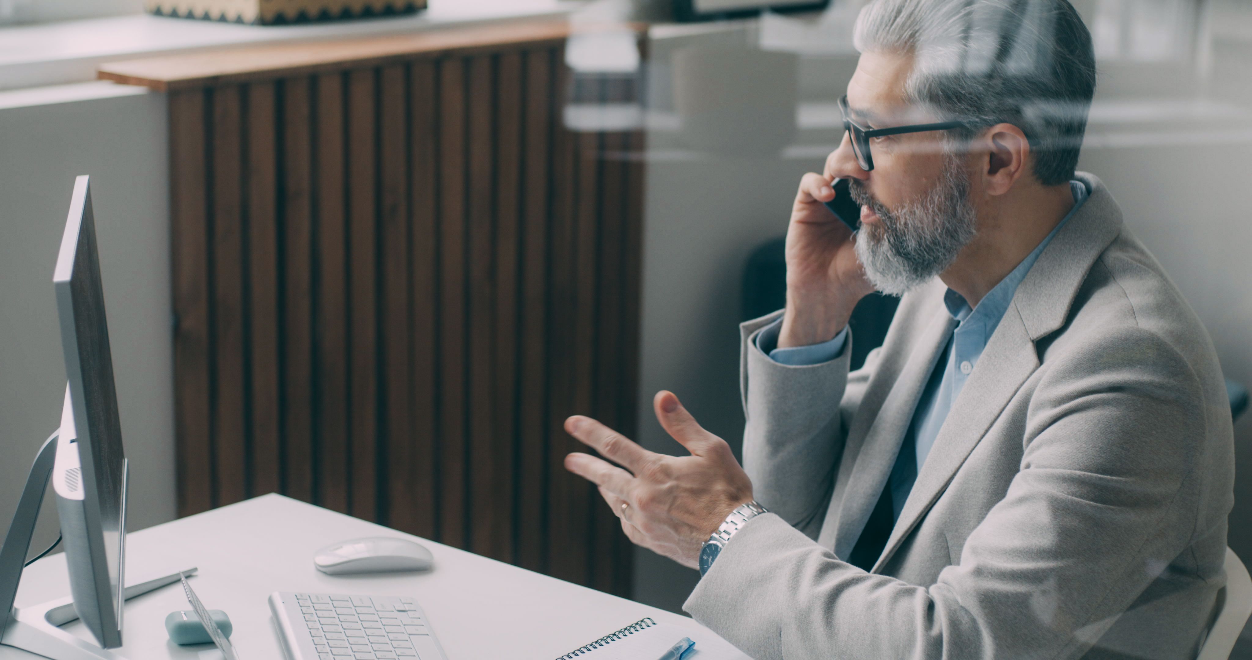 couple investors sitting at table and taking dollar banknotes from advisor in office